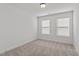 A carpeted bedroom with two windows, offering plenty of natural light at 953 Alma Railway Dr, Wake Forest, NC 27587