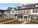 Attractive townhomes showcase varied color palettes, complementary brick accents, and professionally maintained lawns at 953 Alma Railway Dr, Wake Forest, NC 27587