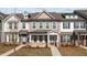 Charming townhome with covered porch, brick accents, neutral siding, and well-maintained landscaping at 953 Alma Railway Dr, Wake Forest, NC 27587