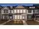Charming townhome with covered porch, brick accents, neutral siding, and well-maintained landscaping at 953 Alma Railway Dr, Wake Forest, NC 27587