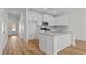 Modern kitchen features white cabinets, granite countertops, stainless steel appliances, and hardwood floors at 953 Alma Railway Dr, Wake Forest, NC 27587
