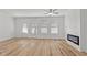 Spacious living room features hardwood floors, a fireplace, three large windows, and access to outdoor patio at 953 Alma Railway Dr, Wake Forest, NC 27587