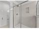 Modern walk-in shower features a glass door, tiled walls, and corner shelves at 953 Alma Railway Dr, Wake Forest, NC 27587