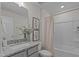 Bright bathroom featuring a granite vanity, framed art, and a shower with white tiling at 959 Alma Railway Dr, Wake Forest, NC 27587