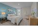 Comfortable bedroom with bright blue accent wall, neutral decor, and natural lighting at 959 Alma Railway Dr, Wake Forest, NC 27587
