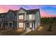 Charming townhome featuring a combination of stone and siding, complemented by a welcoming front porch at 959 Alma Railway Dr, Wake Forest, NC 27587
