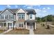 Charming townhome featuring a combination of stone and siding, complemented by a welcoming front porch at 959 Alma Railway Dr, Wake Forest, NC 27587