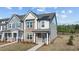 Charming townhome featuring a combination of stone and siding, complemented by a welcoming front porch at 959 Alma Railway Dr, Wake Forest, NC 27587