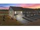 Dusk view of townhomes with attached garages, showcasing modern design and community setting at 959 Alma Railway Dr, Wake Forest, NC 27587