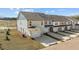 Exterior view of newly built townhomes featuring attached garages and modern design elements at 959 Alma Railway Dr, Wake Forest, NC 27587