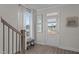 Bright foyer with hardwood floors, a staircase, and natural light from the door and nearby window at 959 Alma Railway Dr, Wake Forest, NC 27587