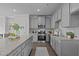Modern kitchen featuring gray cabinets, granite countertops, and stainless steel appliances at 959 Alma Railway Dr, Wake Forest, NC 27587