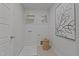 Well lit laundry room featuring wire shelving, woven basket, and neutral decor at 959 Alma Railway Dr, Wake Forest, NC 27587