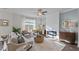 Cozy living area with a fireplace, large window with natural light, and comfortable seating arrangement at 959 Alma Railway Dr, Wake Forest, NC 27587