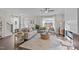 Inviting living room with a fireplace, plush sofa, and large windows offering scenic views and ample sunlight at 959 Alma Railway Dr, Wake Forest, NC 27587