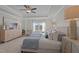 Elegant primary bedroom featuring a tray ceiling, a large window with a view, and a cozy king bed at 959 Alma Railway Dr, Wake Forest, NC 27587