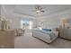 Serene primary bedroom with a tray ceiling, a large window, and a comfortable king-sized bed with luxury linens at 959 Alma Railway Dr, Wake Forest, NC 27587