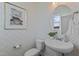 Charming powder room with diamond patterned wallpaper, pedestal sink, and decorative mirror at 959 Alma Railway Dr, Wake Forest, NC 27587