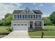 Two-story house with gray siding, white trim, and a two-car garage at 521 Impala Trce, Wendell, NC 27591