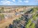 Scenic aerial view of a home nestled on a golf course with mature trees and blue skies at 649 Riverwood Dr, Clayton, NC 27527