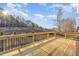 Wooden back deck overlooking grass and trees in a fenced yard at 649 Riverwood Dr, Clayton, NC 27527