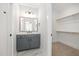 Bathroom featuring gray vanity, sleek black fixtures, and entry to a walk-in closet at 649 Riverwood Dr, Clayton, NC 27527