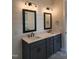 Bathroom featuring a double vanity with modern fixtures, shiplap wall, and framed mirrors at 649 Riverwood Dr, Clayton, NC 27527