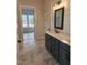 Bathroom with a double sink, gray vanity, white countertop, and tiled floors and shiplap accent wall at 649 Riverwood Dr, Clayton, NC 27527