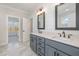 Bathroom with dual-sink vanity, quartz countertop, and modern lighting fixtures at 649 Riverwood Dr, Clayton, NC 27527