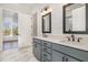 Bathroom features double vanity with gray cabinets and a view of the backyard at 649 Riverwood Dr, Clayton, NC 27527