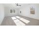 Bedroom featuring plush carpet, modern fan, and a wall of windows at 649 Riverwood Dr, Clayton, NC 27527