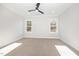 Bedroom featuring plush carpet, neutral walls, ceiling fan, and windows at 649 Riverwood Dr, Clayton, NC 27527