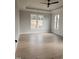 Spacious bedroom with neutral walls, hardwood floors, and large windows providing plenty of natural light at 649 Riverwood Dr, Clayton, NC 27527