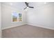 Bedroom with plush carpeting, large windows, and a modern ceiling fan at 649 Riverwood Dr, Clayton, NC 27527