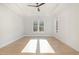 Sunlit bedroom features hardwood floors, neutral walls, ceiling fan, and tray ceiling at 649 Riverwood Dr, Clayton, NC 27527