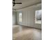 Bright bedroom featuring hardwood floors, modern paneling, and natural light from multiple windows at 649 Riverwood Dr, Clayton, NC 27527