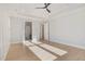Bright bedroom features hardwood floors, neutral walls, ceiling fan, and tray ceiling at 649 Riverwood Dr, Clayton, NC 27527