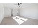 Spacious bedroom with plush carpet, tray ceiling, and modern ceiling fan at 649 Riverwood Dr, Clayton, NC 27527