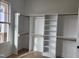 Spacious closet with white built-in shelves and wooden rods for optimal storage solutions at 649 Riverwood Dr, Clayton, NC 27527