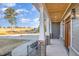 Inviting front porch with brick accents, iron railing and view of the golf course at 649 Riverwood Dr, Clayton, NC 27527