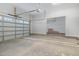 Spacious garage with a large overhead door, concrete floor, and ample storage space at 649 Riverwood Dr, Clayton, NC 27527