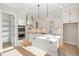 Modern kitchen features white cabinets, stainless appliances, herringbone backsplash, and center island at 649 Riverwood Dr, Clayton, NC 27527