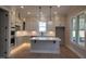 Stylish kitchen with modern appliances, white cabinetry and a large center island with pendant lighting at 649 Riverwood Dr, Clayton, NC 27527