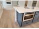 Kitchen island with cabinets, microwave, and quartz countertop offering seating and prep space at 649 Riverwood Dr, Clayton, NC 27527