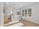 Bright, white kitchen with center island, stainless steel appliances, and hardwood floors at 649 Riverwood Dr, Clayton, NC 27527