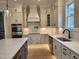 Bright kitchen with white cabinets, stainless steel appliances, a pot filler, and plenty of counter space at 649 Riverwood Dr, Clayton, NC 27527