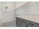 Well-lit laundry room with stylish patterned floors, cabinets and a countertop at 649 Riverwood Dr, Clayton, NC 27527