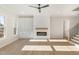 Living room with fireplace, built-in shelving, a ceiling fan, and hardwood floors at 649 Riverwood Dr, Clayton, NC 27527
