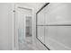 Modern shower with glass door, and marble-look tile continuing into a walk-in closet at 649 Riverwood Dr, Clayton, NC 27527