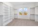 Spacious walk-in closet with built-in shelving and view of the outdoors at 649 Riverwood Dr, Clayton, NC 27527